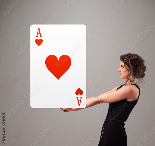 Photo: Beautifu woman holding a red heart ace Beautifu woman holding a red heart ace