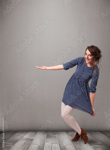 Photo: Pretty woman presenting an empty copy space Pretty woman presenting an empty copy space