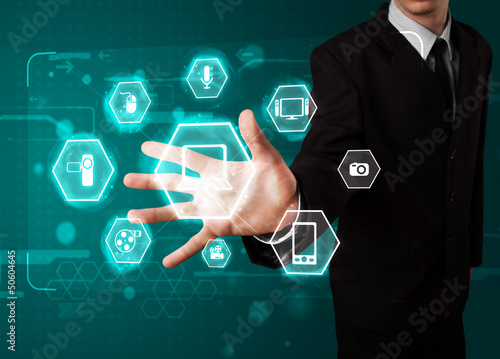 Photo: Businessman pressing virtual media type of buttons Businessman pressing virtual media type of buttons