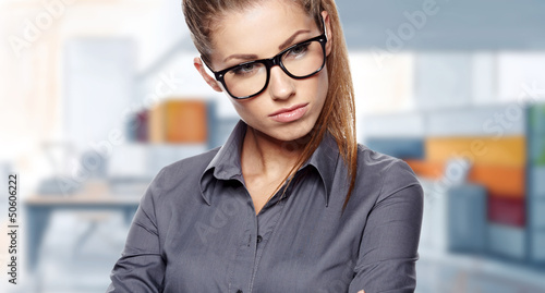 Photo: A portrait of a young business woman in an office A portrait of a young business woman in an office