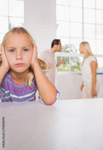 Photo: Sad girl with fighting parents Sad girl with fighting parents