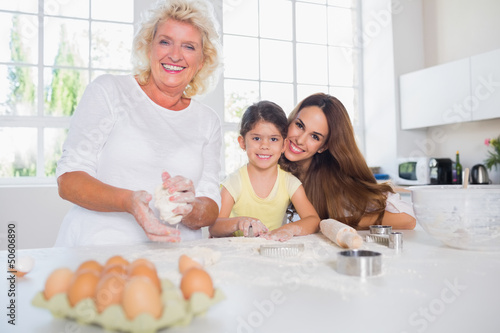 Photo: Smiling women of a family baking together Smiling women of a family baking together