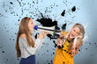 Girl shouting at another through megaphone