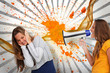 Girl shouting at her friend through a megaphone