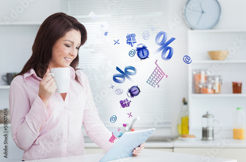 Photo: Woman using applications from tablet Woman using applications from tablet