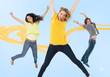 Three happy friends jumping for joy