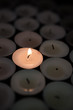 Single candle lighting in the dark