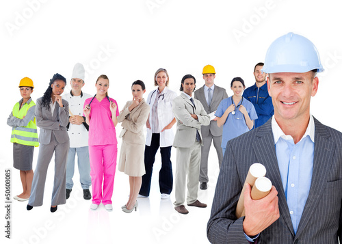Photo: Architect standing in front of different types of workers Architect standing in front of different types of workers