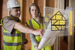 Architect and foreman consulting the plans on interface
