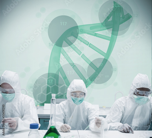 Photo: Chemists working in protective suit with futuristic interface sh Chemists working in protective suit with futuristic interface sh