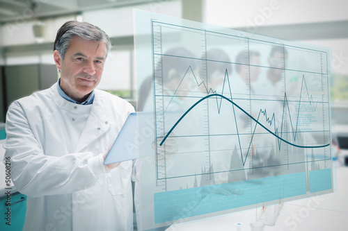 Photo: Confident scientist working with tablet and futuristic interface Confident scientist working with tablet and futuristic interface
