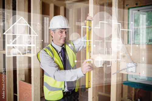 Photo: Architect using spirit level while looking at white hologram int Architect using spirit level while looking at white hologram int