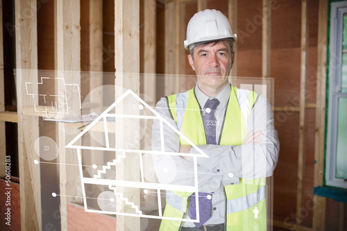 Photo: Architect standing behind white house plan interface Architect standing behind white house plan interface