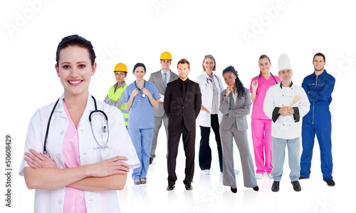 Photo: Smiling doctor in front of a team of different workers Smiling doctor in front of a team of different workers