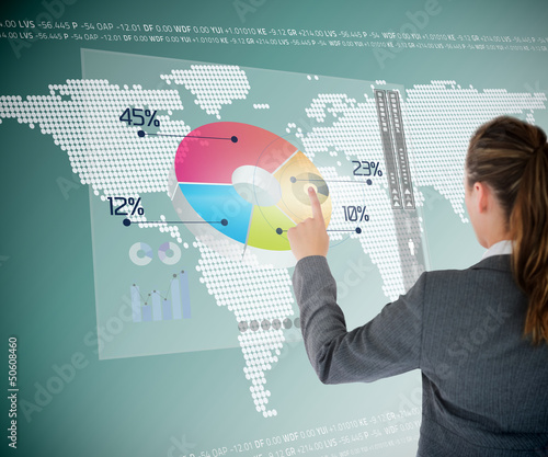 Photo: Businesswoman using colorful transparent futuristic interface Businesswoman using colorful transparent futuristic interface