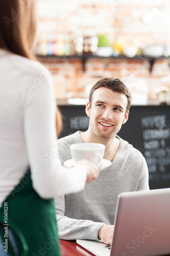 Photo: Waitress serving man at cafe Waitress serving man at cafe