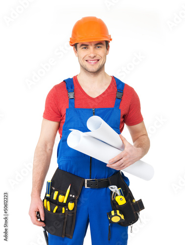 Photo: Smiling handyman with tools and paper Smiling handyman with tools and paper