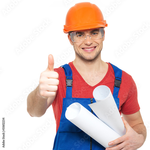 Photo: handyman with paper showing thumbs up sign handyman with paper showing thumbs up sign