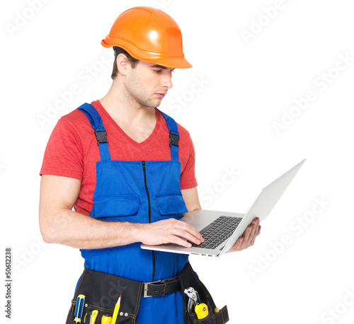 Photo: handyman with laptop isolated on white handyman with laptop isolated on white