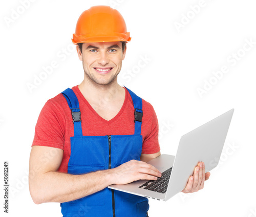 Photo: handyman with laptop isolated on white handyman with laptop isolated on white