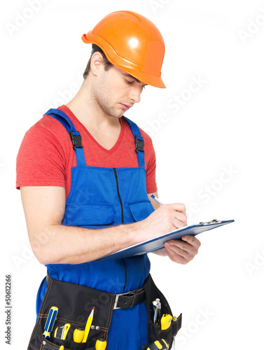 Photo: worker with tools, planning and writing the note worker with tools, planning and writing the note