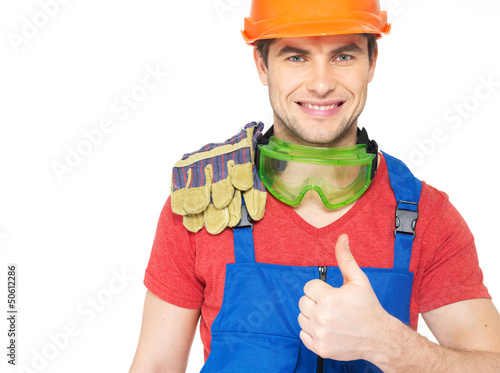 Photo: Portrait of smiling worker shows thumbs up Portrait of smiling worker shows thumbs up