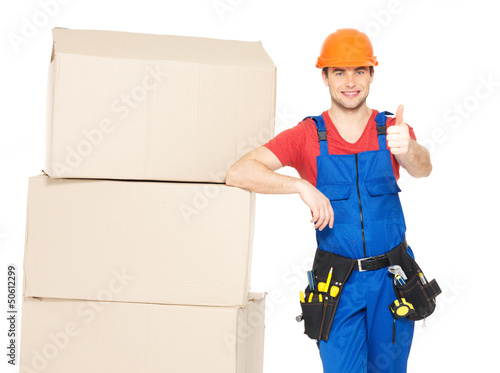 Photo: worker delivery man with boxes showing thumbs up worker delivery man with boxes showing thumbs up