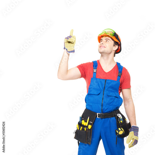 Photo: Worker with tools points up with finher Worker with tools points up with finher