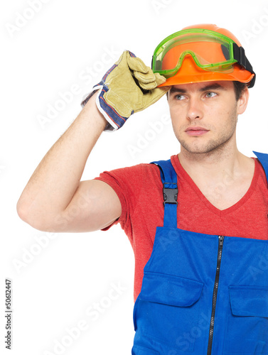 Photo: portrait of thinking handyman in uniform portrait of thinking handyman in uniform