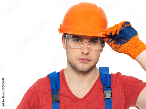 Photo: portrait of thinking handyman in uniform portrait of thinking handyman in uniform