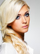 Beautiful blond woman with long curly hair and style makeup.