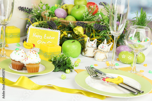 Photo: Serving Easter table on room background Serving Easter table on room background