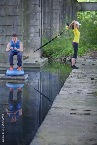 Photo: professional sporty man and woman outdoor training professional sporty man and woman outdoor training