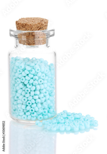 Photo: Little bottle full with colorful beads isolated on white Little bottle full with colorful beads isolated on white