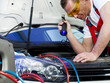 Motor mechanic checking the air handling unit of a car