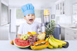 Happy boy blends healthy fruit juice at home