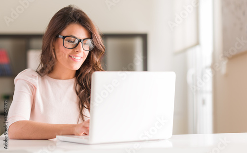 Photo: Young Woman Using Laptop Young Woman Using Laptop