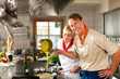 Foto: Chefs in a restaurant or hotel kitchen cooking Chefs in a restaurant or hotel kitchen cooking