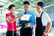 Worker, manager and designer in garment factory