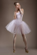 Charming Woman in White Tutu with Pearly Beads over Grey. Ballet