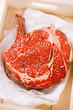 Bone-in Rib eye Steak steak on paper and wooden table