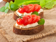 Warm bread tomatoes, cream cheese and basil