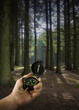 lost man holding compass with two paths to choose from