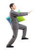 Full length portrait of a man in pajamas sleepwalking with a pil