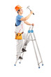 Full length portrait of a repairman on a ladder working with a h