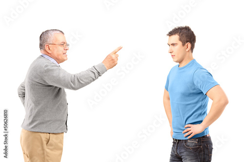 Photo: Angry father reprimanding his son with finger Angry father reprimanding his son with finger