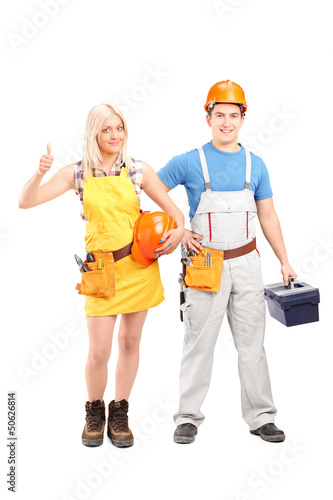Photo: Full length portrait of a male and female construction workers w Full length portrait of a male and female construction workers w