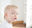 little boy is looking at the camera