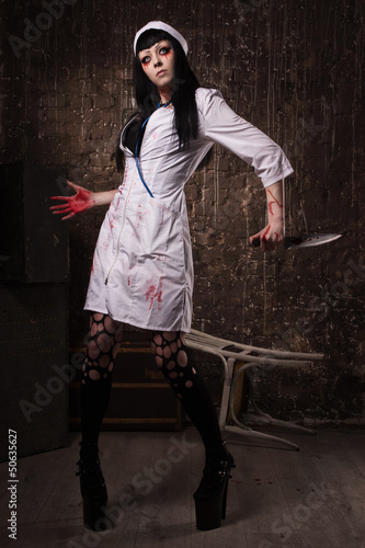 Photo: Crazy dead nurse with knife in the hand Crazy dead nurse with knife in the hand
