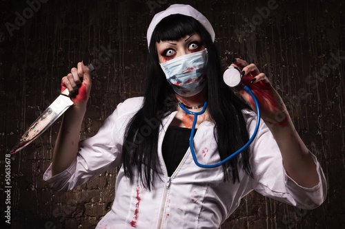 Photo: Crazy dead nurse with knife in the hand Crazy dead nurse with knife in the hand